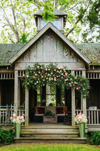 a house with a gazebo with roses on it at Roanoke Island Inn in Manteo