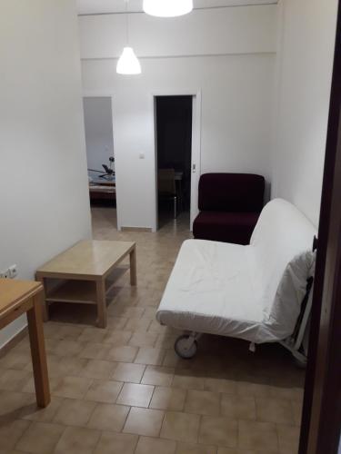 a hospital room with a bed and a chair at apt 30m from beach in Amarinthos