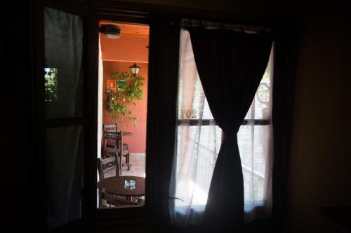 a window view of a dining room with a table at Hotel Rivera in Colonia del Sacramento