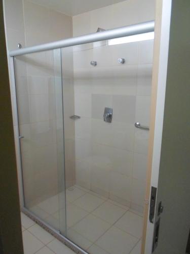 a shower with a glass door in a bathroom at Coqueiros Express Hotel in Maceió