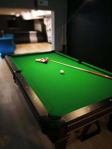 a green snooker table with a ball on it at Hotel Portofino in Włocławek