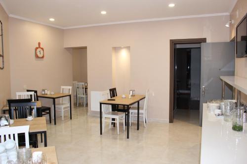 a restaurant with tables and chairs and a clock on the wall at Boutique Hotel 32 in Batumi