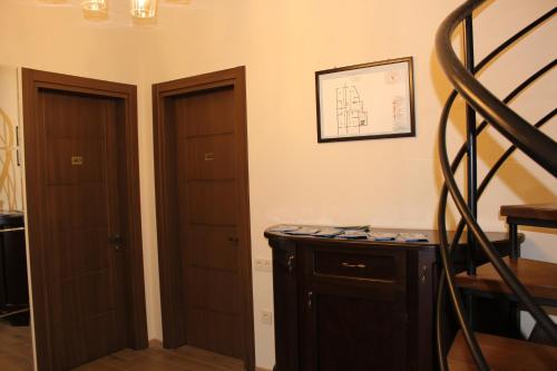 a room with two wooden doors and a staircase at Boutique Hotel 32 in Batumi
