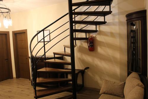 a black spiral staircase in a living room at Boutique Hotel 32 in Batumi
