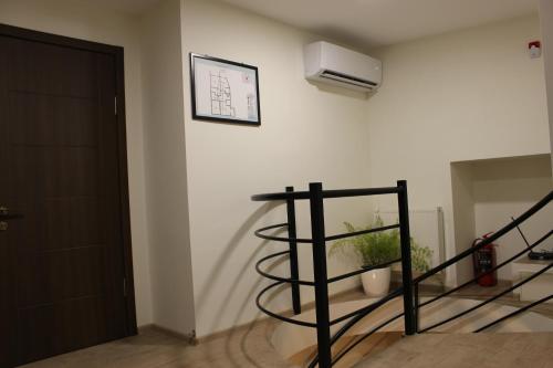 a room with a staircase with a plant on the wall at Boutique Hotel 32 in Batumi