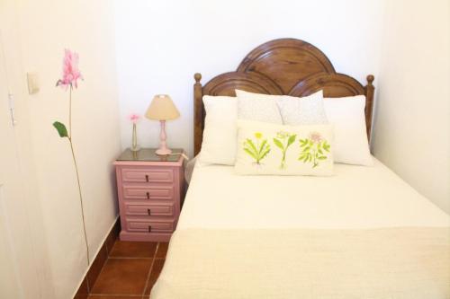 a bedroom with a bed with a wooden headboard at Hope House in Póvoa de Varzim