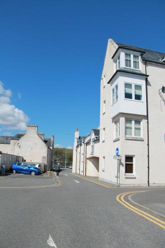 a white building on the side of a street at No.10 in Stornoway