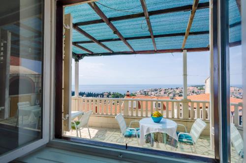 a view from the window of a balcony with a table and chairs at Rooms Nikola in Dubrovnik