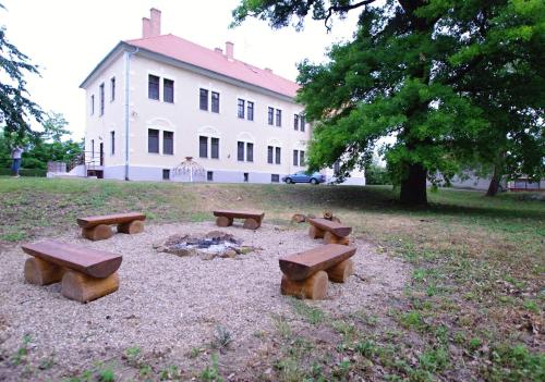 a group of picnic tables in front of a building at Koleje Zamecek in Lednice