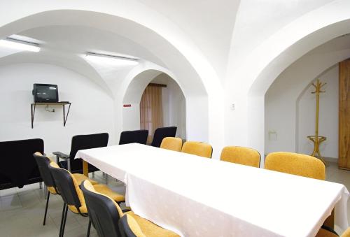 a conference room with a white table and chairs at Koleje Zamecek in Lednice