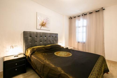 a bedroom with a large bed with a black headboard at Penthouse with amazing views in Vina del Mar in Playa Fañabe