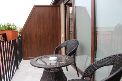 a patio with two chairs and a table on a balcony at Boutique Hotel 32 in Batumi