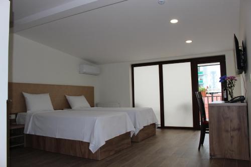 a bedroom with a large bed with white sheets at Boutique Hotel 32 in Batumi