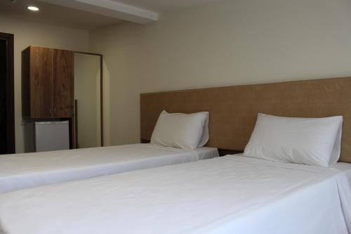 two beds sitting next to each other in a room at Boutique Hotel 32 in Batumi