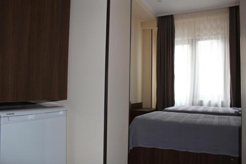 a bedroom with a bed and a window at Boutique Hotel 32 in Batumi