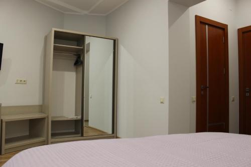a bedroom with a mirror and a bed at Boutique Hotel 32 in Batumi