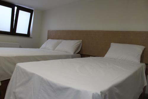 two beds sitting next to each other in a room at Boutique Hotel 32 in Batumi