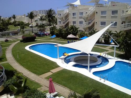 a view of a swimming pool in front of a building at Pent House Acapulco Diamante Markis K 31 in Acapulco