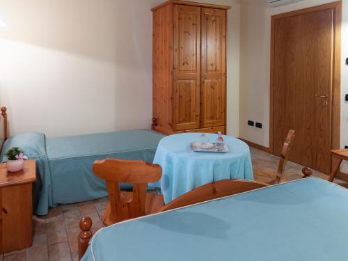 a room with a blue bed and a table at Agriturismo Il Palazzone in Montegalda