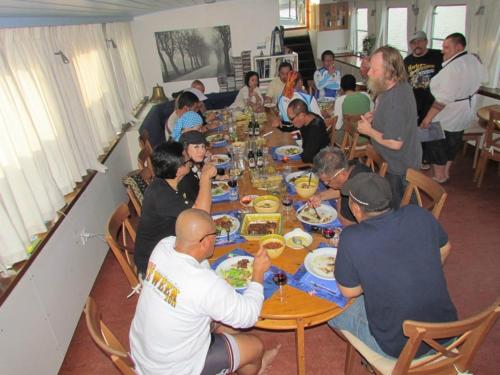 a group of people sitting around a table eating food at Hotelschip Gandalf in Amsterdam