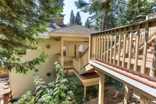 a house with a large deck and a staircase at Pine Arbor Retreat in Yosemite West