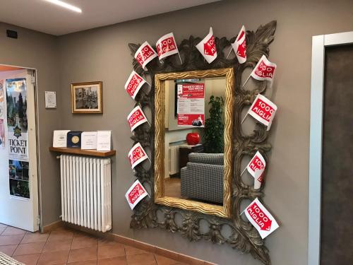 a mirror with christmasmas signs on a wall at Hotel Villa Rosa in Sirmione