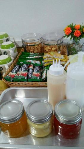 a refrigerator filled with food and jars of food at Tamruethai House - ตามฤทัยเฮาส์ in Chiang Mai