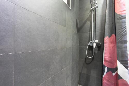 a bathroom with a shower with a glass door at Amazing Penthouse old town in Sarajevo