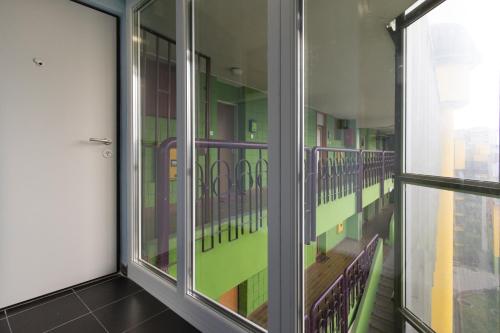 a room with a balcony with purple and green at Amazing Penthouse old town in Sarajevo