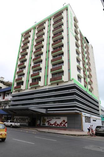 a large white building on the side of a street at Hotel Caribe Panamá in Panama City