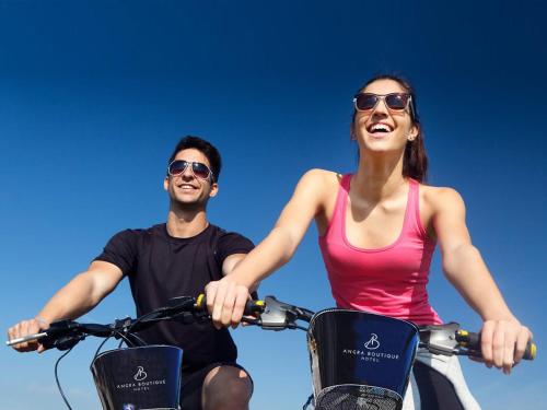 a man and a woman riding on a bike at Angra Boutique Hotel in Angra dos Reis