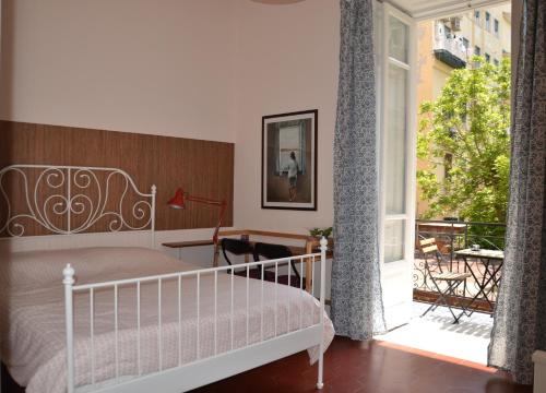 a bedroom with a bed and a balcony at Casa Arcoiris in Naples