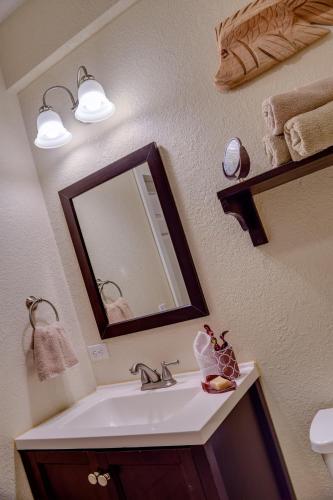 a bathroom with a sink and a mirror at SeaScape in West End