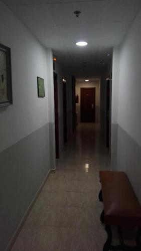 a hallway in a building with a wooden table and a hallway sidx sidx at Hotel Inglés in Barcelona