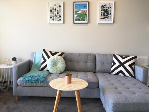 a living room with a couch and a table at Boulevard Waters in Taupo