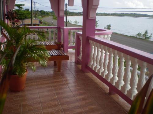 a porch with a bench and a view of the water at Beya Suites in Punta Gorda