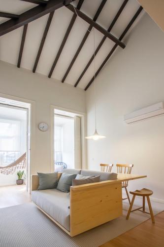 a living room with a couch and a table at Republica Apartments at D. Luis I Bridge in Vila Nova de Gaia