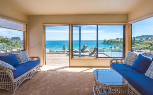 a living room with a view of the ocean at Palm Beach Lodge in Palm Beach