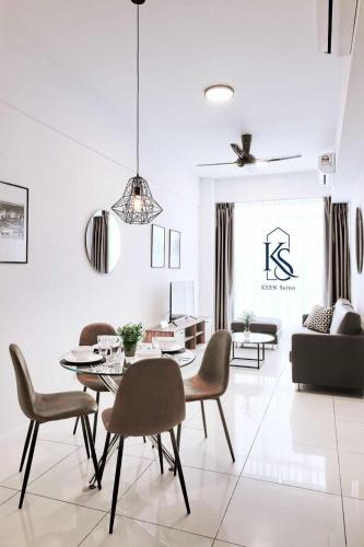 a white living room with a table and chairs at KEEN Suites@Sutera Avenue in Kota Kinabalu