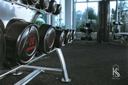a row of dumbbells on a rack in a gym at KEEN Suites@Sutera Avenue in Kota Kinabalu