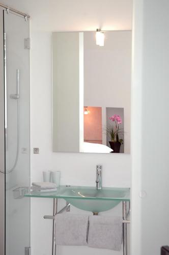a bathroom with a glass sink and a mirror at Hotel Heidelberg Astoria in Heidelberg
