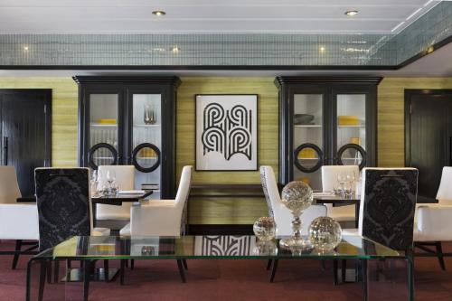 
a room with a table, chairs, and a table cloth at Hotel St Moritz Queenstown - MGallery by Sofitel in Queenstown
