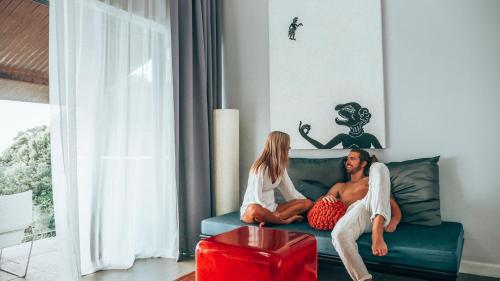 a man and a woman sitting on a couch at The Houben - Adult Only in Ko Lanta