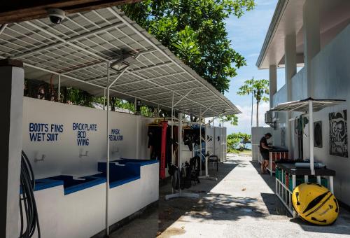 a white building with awnings on the side of it at Cabilao Sanctuary Beach & Dive Resort in Loon