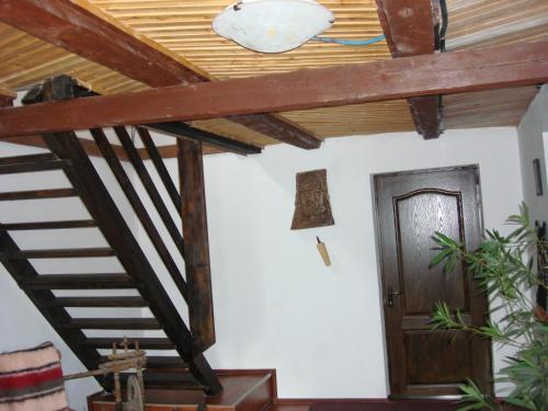 a room with a wooden ceiling and a door at Cabana Ada 1 in Vartop