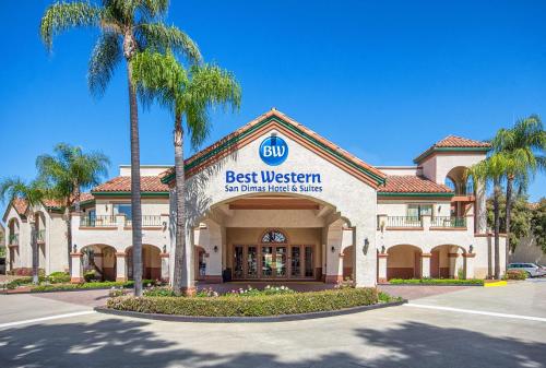a best western building with palm trees in front of it at Best Western San Dimas Hotel & Suites in San Dimas