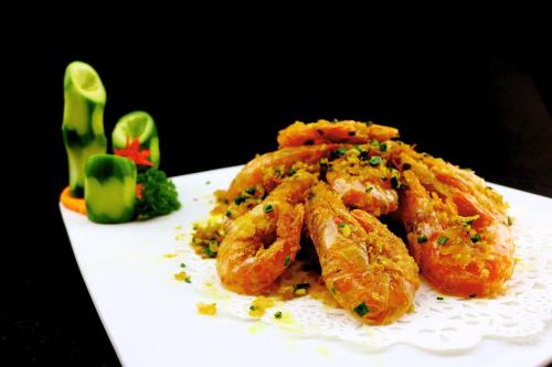 a white plate of food with shrimp on it at Narada Resort & Spa Perfume Bay Sanya - All Villas in Lingshui