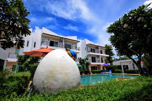 a large rock in front of a house at Pool Access 89 @Rawai Hotel in Rawai Beach