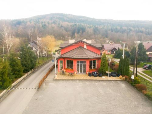 a house on the side of a road at Hotel Krak in Myślenice