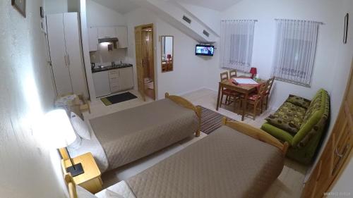 a room with two beds and a table and a chair at Hotel Krak in Myślenice